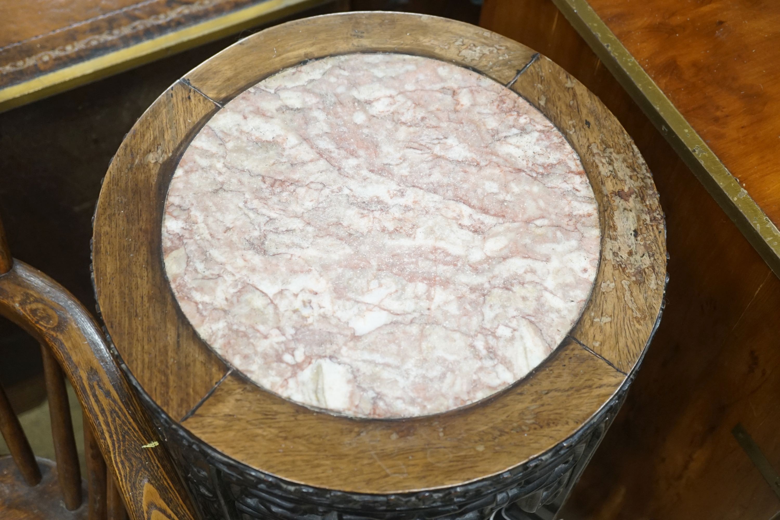 A Chinese circular marble topped padouk three tier vase stand, diameter 34cm, height 80cm